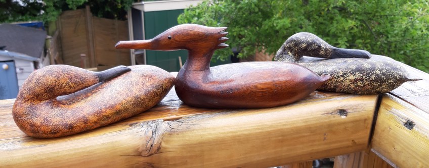 Image of three wooden ducks